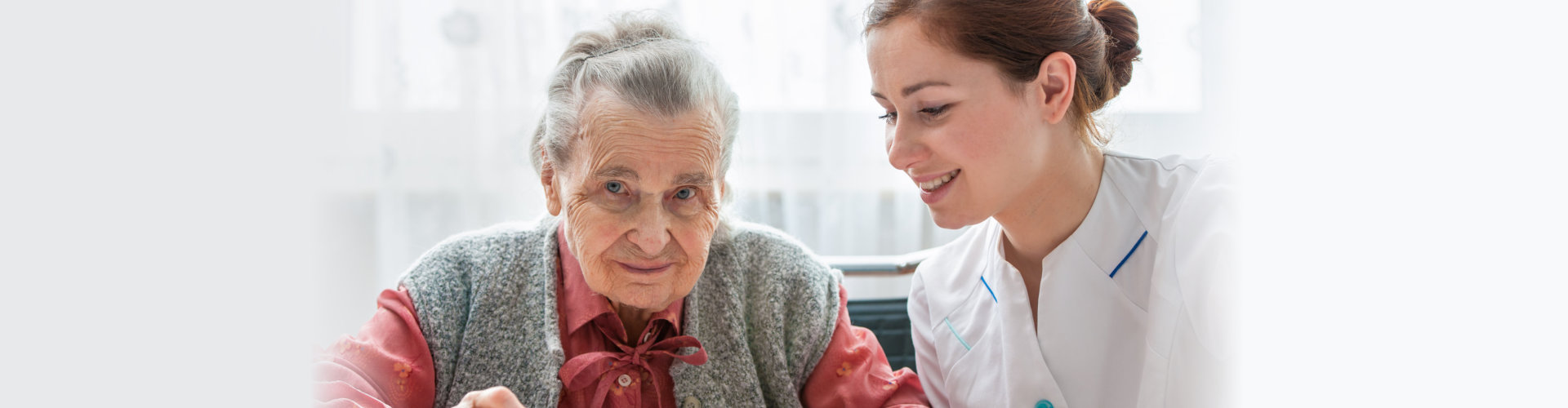 nurse looking after elderly woman